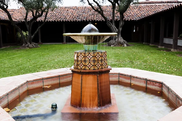 Flowing Fountain In Court Yard Red Tile Roof