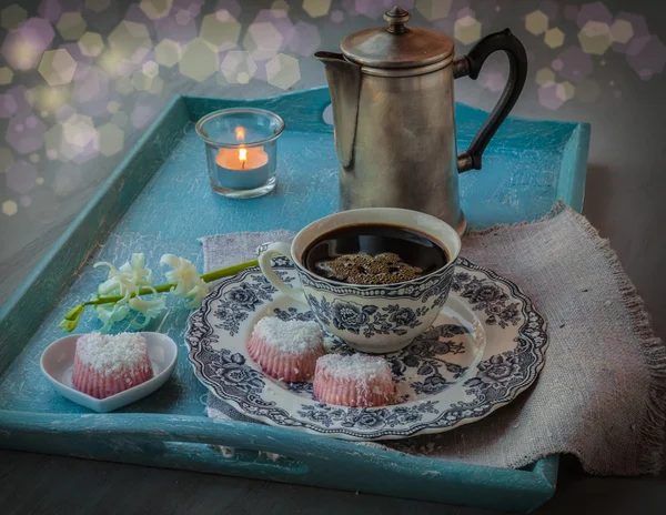 Tray with a coffee pot, cup of coffee, candle and  candies