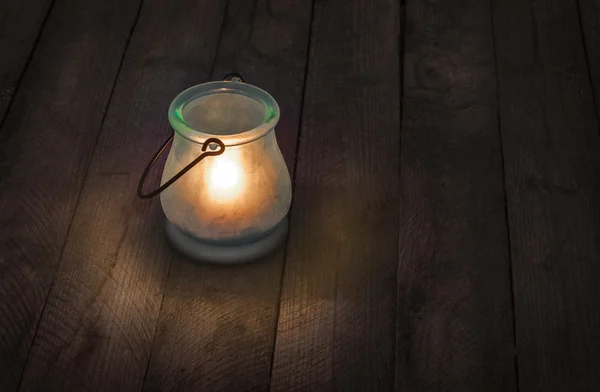 Burning glass lantern at night