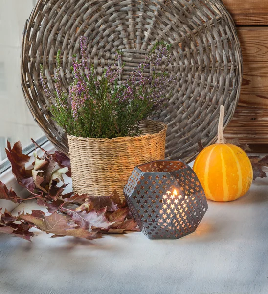 Heather in a basket next to a candle