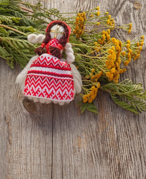 Tansy and folk doll on wooden table