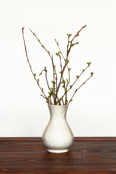 Vase with branches on the table