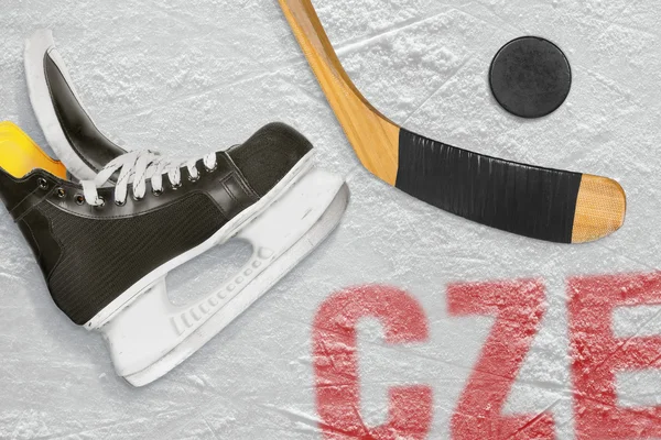 Czech hockey stick, skates and the puck on the ice