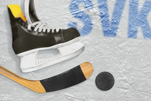 Slovak hockey stick, skates and the puck on the ice