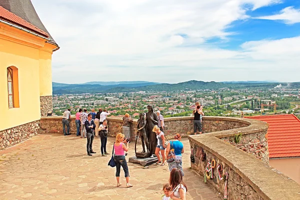 Unidentified people in Palanok Castle or Mukachevo Castle, Zakarpattya,  Ukraine, built in 14th century. The Palanok Castle is delicately preserved, and is located on a former 68 metre high volcanic hill