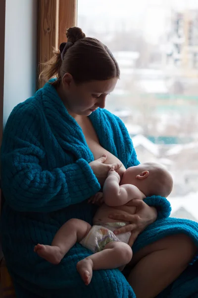 Woman and her baby, breastfeeding