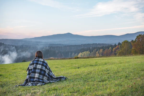 Adventure woman sitting in mountains