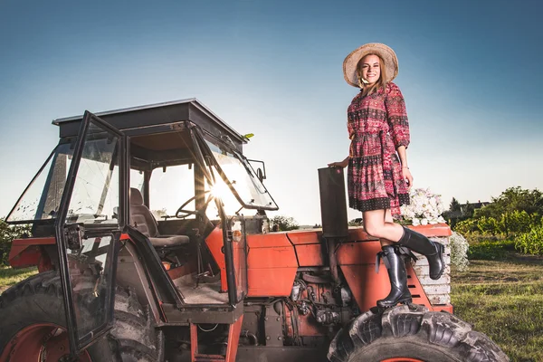 Farmer woman by tractor