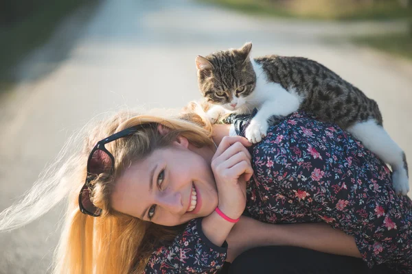 Woman playing with  cat
