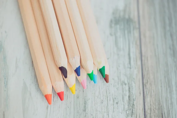 Assortment of colored pencils/Colored Drawing Pencils/Colored drawing pencils in a variety of colors on vintage wooden background