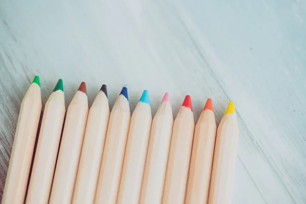 Assortment of colored pencils/Colored Drawing Pencils/Colored drawing pencils in a variety of colors on vintage wooden background
