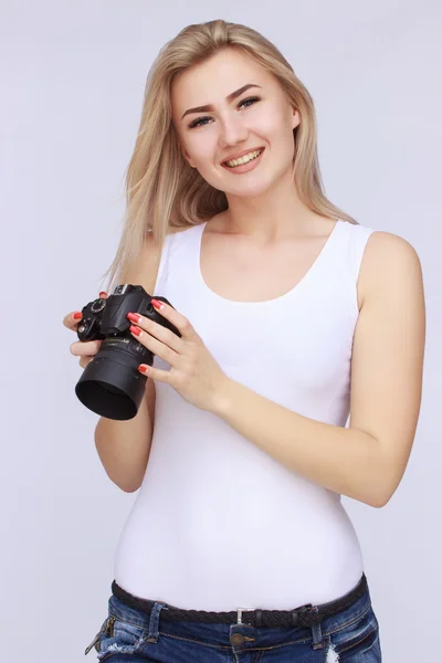 Happy woman holding camera