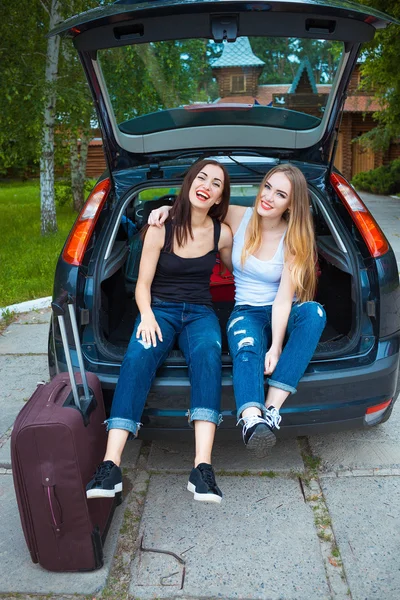 Two girls posing in car