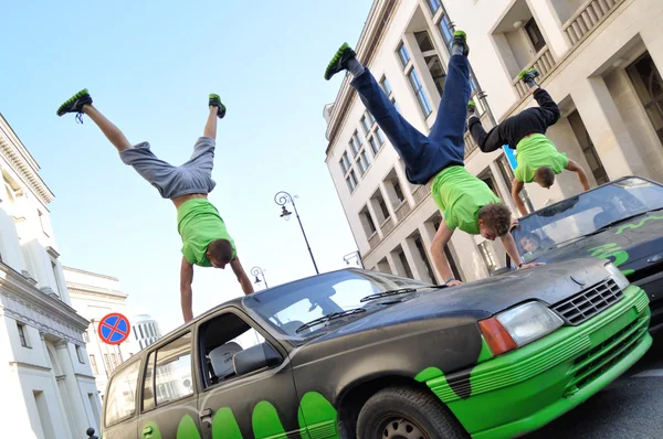 Handstand trick on the top of car.