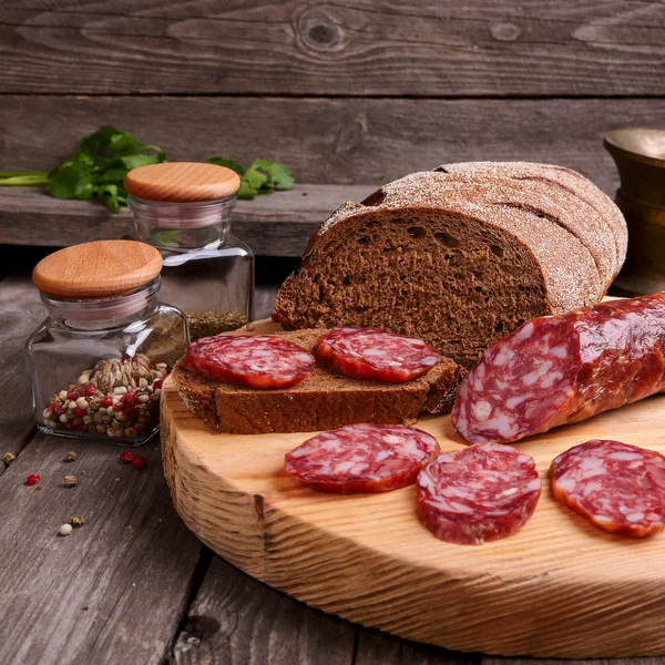 Salami and bread on a cutting board