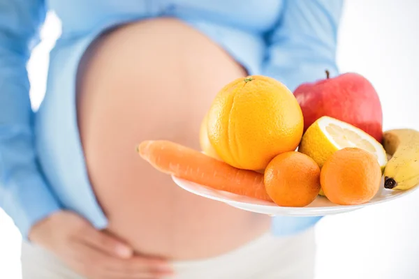 Pregnancy and nutrition diet - pregnant woman with fruits isolat