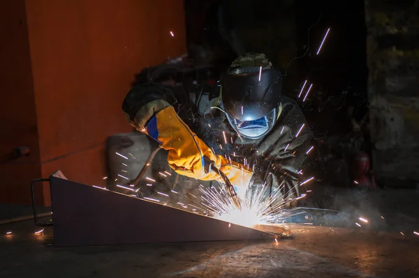 Worker welding metal