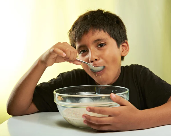 Boy with spoon in mouth