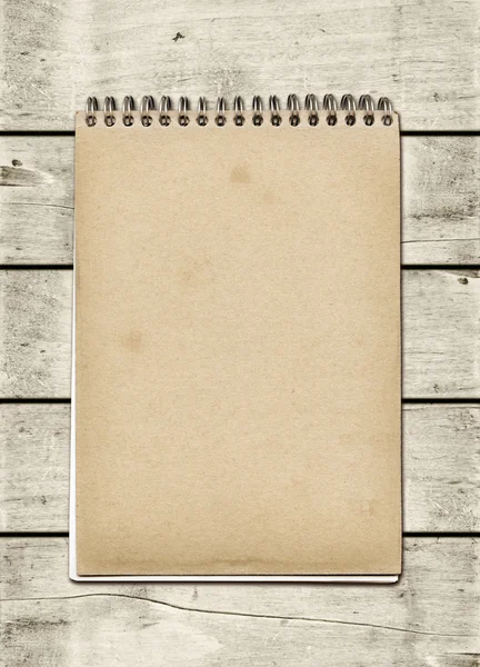 Closed spiral Note book on a white wood table