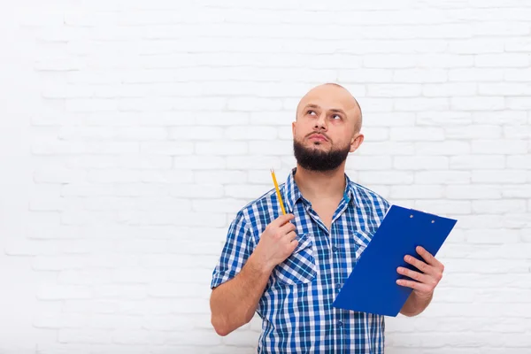 Serious Casual Bearded Business Man Holding Folder Look To Copy Space Pondering Doubtful