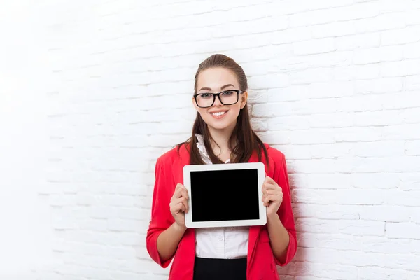 Businesswoman show tablet computer screen with empty copy space wear red jacket glasses happy smile