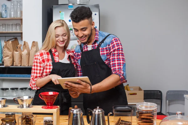 Barista coffee shop couple using tablet computer happy smile