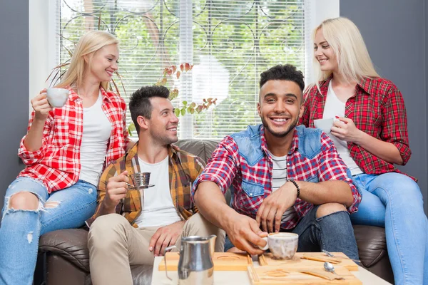 Young people drink coffee shop, friends sitting table smiling