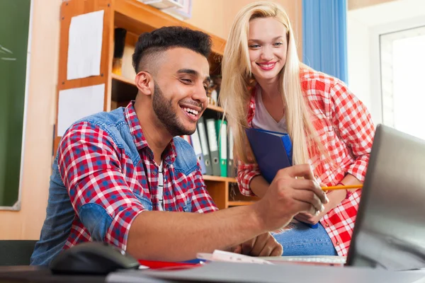Two Young Students in University Classroom, Smiling Hispanic Man Show High School Girl Laptop