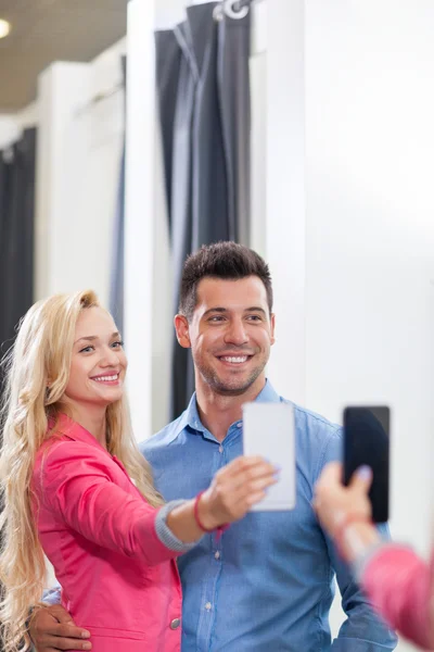 Young Couple Taking Selfie Photo Fitting Room Fashion Shop, Happy Smiling Man And Woman Shopping Customers Trying Clothes