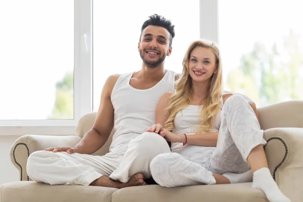 Young Couple Sit On Couch, Happy Smile Hispanic Man And Woman Hug Lovers