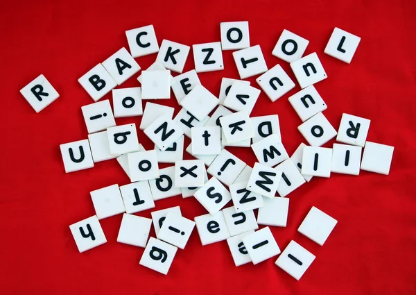 Letter tiles over red background