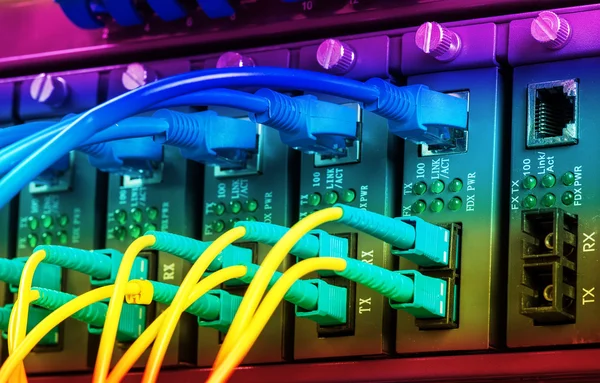 Fiber Optic cables connected to an optic ports and Network cable