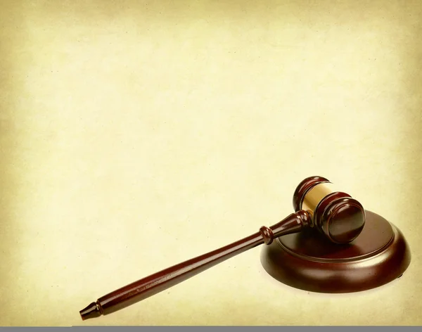Wooden gavel on old paper background, law concept