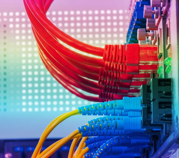 Fiber Optic cables connected to an optic ports and Network cable