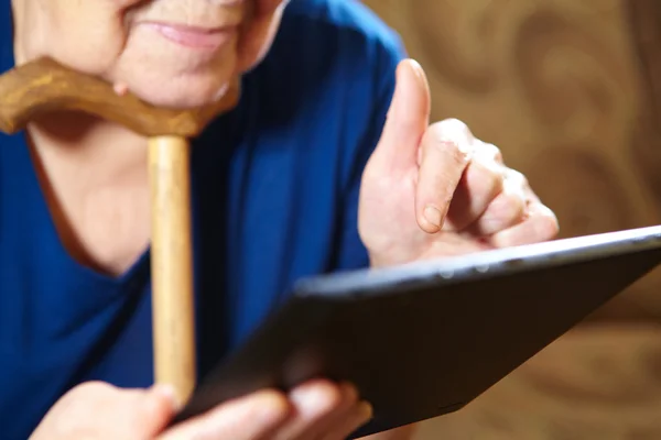 Elderly woman with tablet computer