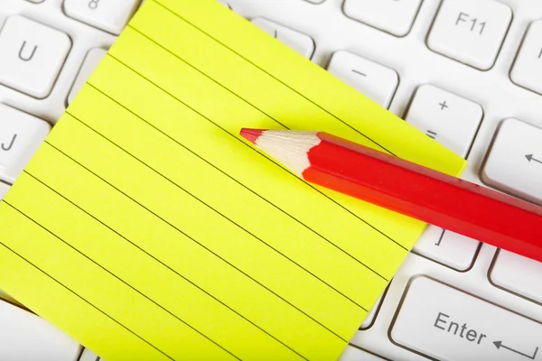 Red pensil and keyboard