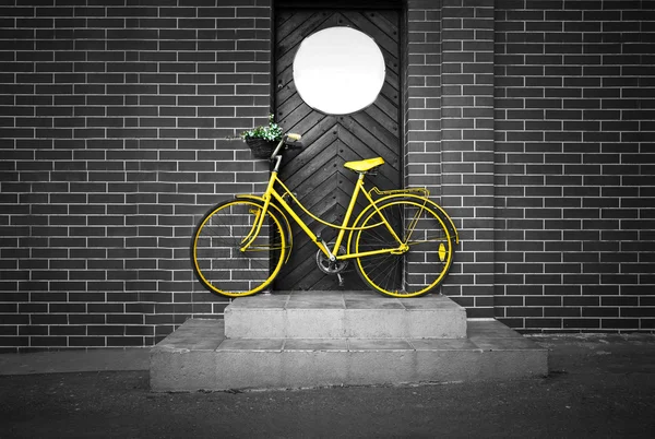 Vintage retro old yellow bike on the street.