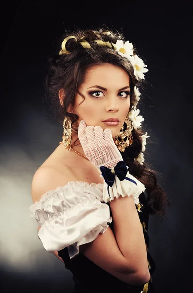 Girl with chamomile in the hair in vintage dress