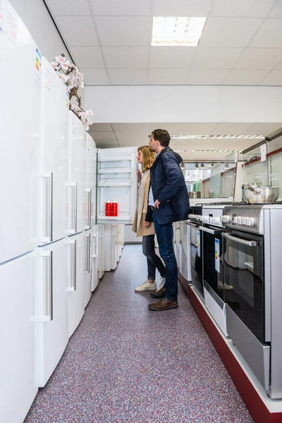 Couple Buying Refrigerator In Hypermarket