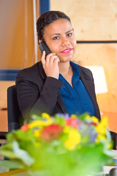 Young receptionist taking calls on a phone