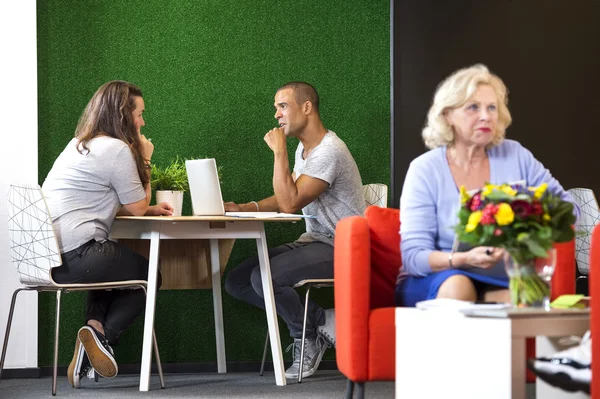 Businesspeople Discussing At Office Lobby