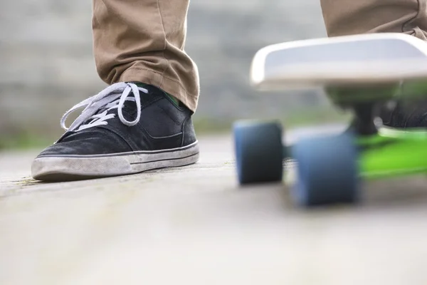 Man With Skateboard On Footpath