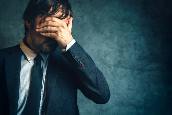 Unhappy businessman under stress after business project failure