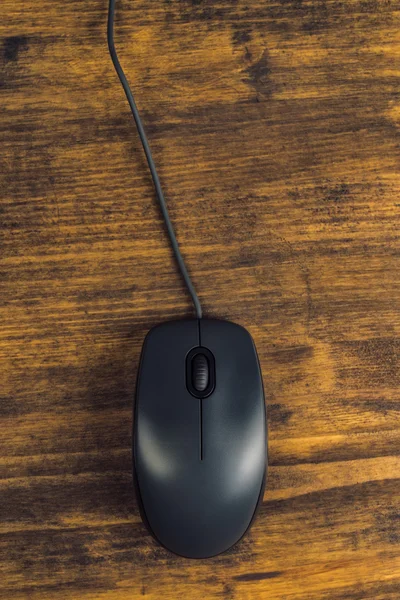 Computer mouse on office desk, top view