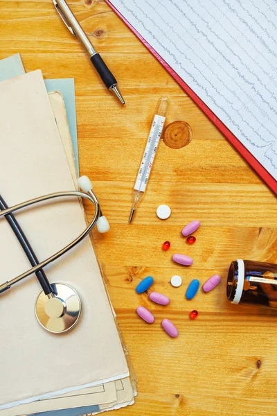 Colorful medical tablets and pills on doctor\'s office desk