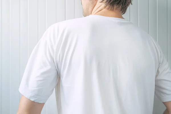 Casual adult male wearing blank white t-shirt from behind