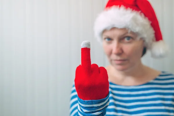 Woman with Christmas Santa Claus hat giving middle finger