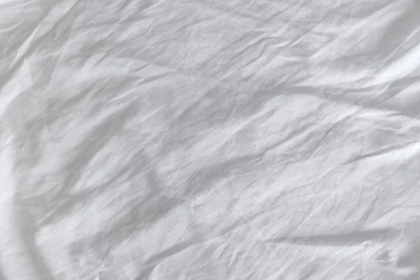 Wrinkles on crumpled white cotton sheets textire