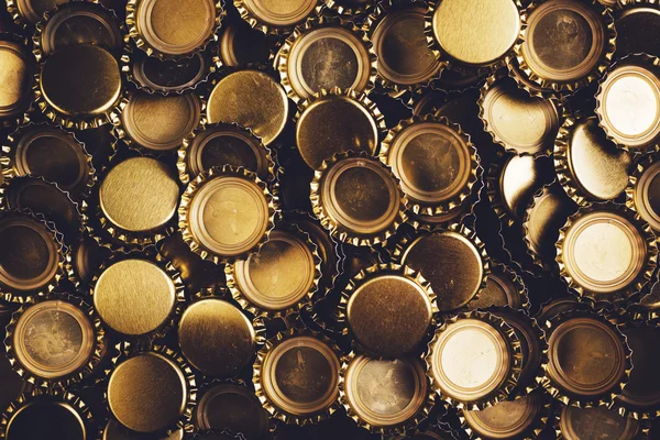 Beer bottle caps heap as background