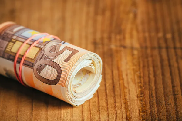 Rolled up cash money, euro banknotes